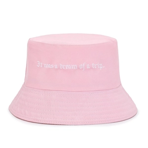 Close-up of pink cotton bucket hat featuring white 'It was a dream' embroidery detail