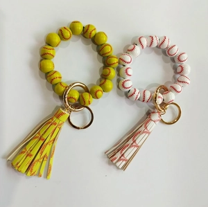 Detail of baseball and softball beaded wristlet keychains with leather tassels and gold clips