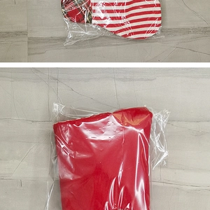 Detail of red and white striped Christmas stockings in transparent plastic packaging