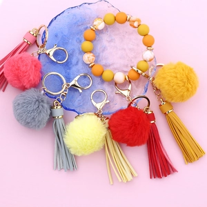 Silicone bead wristlet keychain with colorful faux fur pom poms and leather tassels