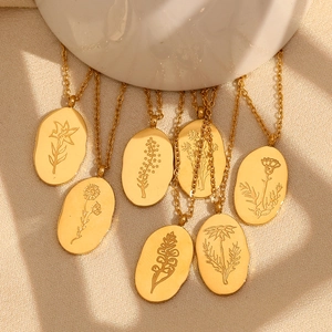 Detailed view of irregular oval gold necklaces with various floral relief pendants