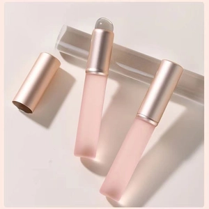 Mini portable rounded lipstick brush with frosted pink handle and rose gold cap