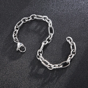 Polished silver stainless steel link bracelet with lobster clasp on black background