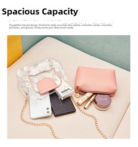 Detailed view of transparent daisy PVC tote with gold cat-ear handles and pink inner pouch