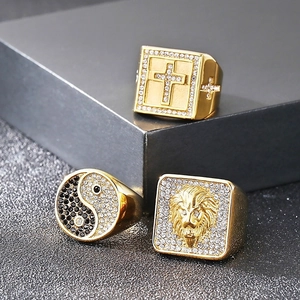 Detailed view of hip hop gold rings featuring lion head, cross, and tai chi patterns