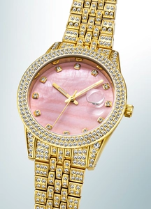 Close-up of luxury gold watch with pink mother of pearl dial and crystal embellishments