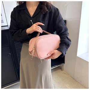 Pink PU leather makeup bag detail showing the sturdy top handle and dual zipper design
