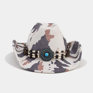 Detail of western cowboy hat featuring turquoise buckle and ethnic beaded decorative band