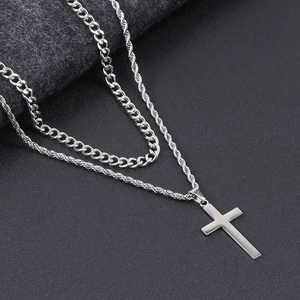 Detail of hip hop double layer necklace featuring Cuban chain and cross pendant