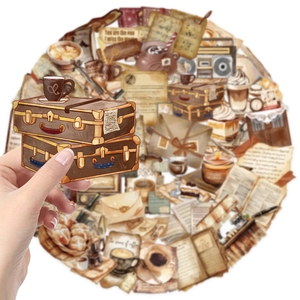 Detail shot of vintage cafe stickers showing clear PET material and retro suitcase designs