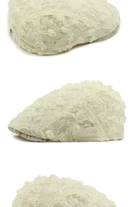 Detail of cream lace flat cap featuring 3D rose floral embroidery and mesh texture