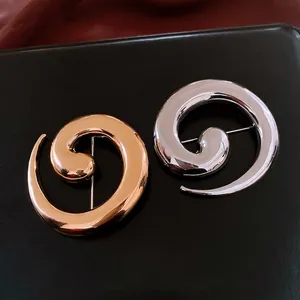 Minimalist spiral swirl metal brooches in polished gold and silver finish for women