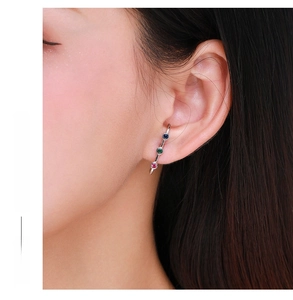 Close-up of S925 silver linear earrings with vertical blue, green, and red zircon stones