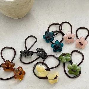 Close-up of colorful acrylic jelly flower hair ties in pink blue and amber tones