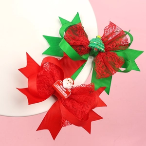 Detail of Christmas bow hair clips with Santa and tree motifs for girls