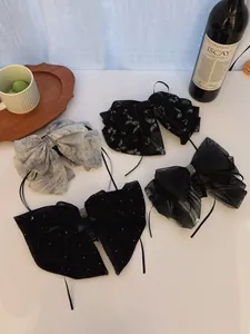 Selection of four chic French chiffon bow hair claws in elegant black and grey patterns