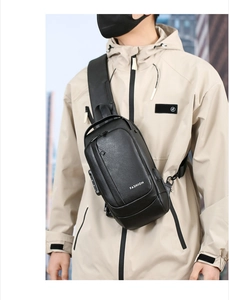 Detail of waterproof black leather chest bag featuring external USB charging port