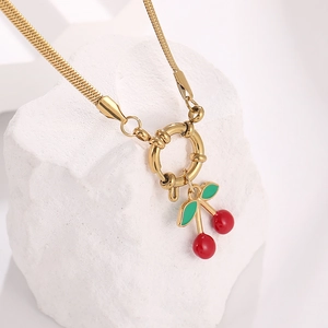 Gold stainless steel necklace with red cherry pendant and spring clasp on stone