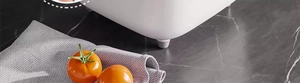Detail view of the one-touch opening button on white kitchen storage container