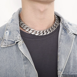 Close-up of matte silver Cuban link chain necklace on model for a bold urban look