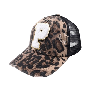 Detail of leopard print baseball cap with white plush P patch and breathable black mesh