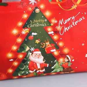 Detail of Christmas non-woven gift bag showing festive tree print and fabric texture