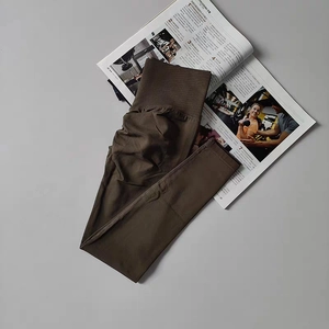 Detail view of coffee brown yoga leggings featuring scrunch butt and high waist design