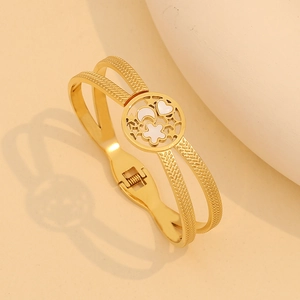 Double-layered gold stainless steel bracelet featuring moon, star and flower charms