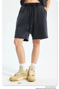 Detail of dark gray washed cotton shorts featuring a drawstring waist and retro texture