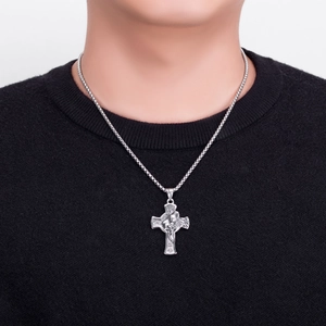 Close-up of a silver lion head cross pendant necklace on a male model in retro punk style