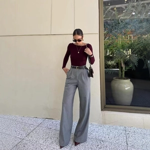 Chic burgundy slim fit knit top and grey striped wide leg pants outfit with belt
