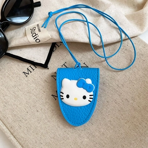 Detail view of a blue Hello Kitty card holder with lanyard on a beige canvas bag
