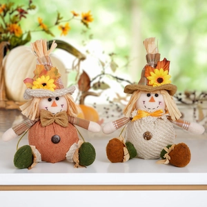 Handcrafted harvest scarecrow dolls in orange and beige for Thanksgiving home decoration