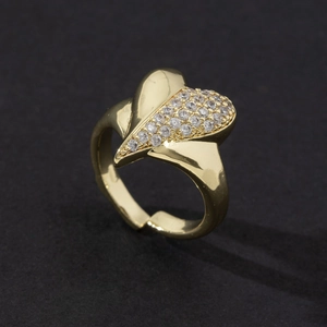 Close-up of heart-shaped gold ring with cubic zirconia stones and adjustable band