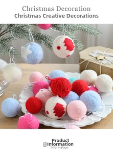 Detail of red and white wool felt Christmas balls with star patterns on a holiday tree