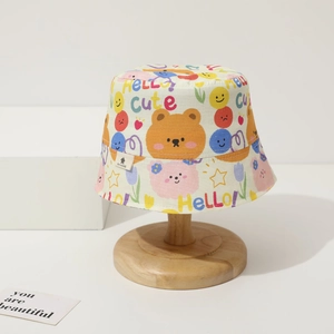 Close-up of cotton baby sun hat featuring colorful cartoon bear and star graffiti prints