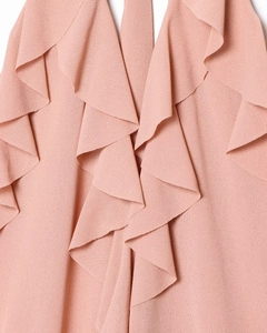 Macro shot of layered ruffles and textured crepe fabric on a halter neck top