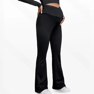 Detail of high waisted maternity yoga pants with crossover support and flared leg design