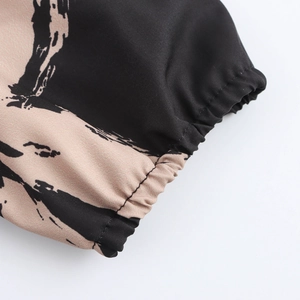 Floral print maxi dress featuring elastic smocked cuffs and abstract ink patterns
