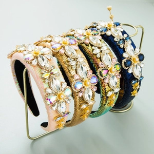 Detail view of four wide headbands with crystals, pearls and floral sequins
