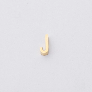 Detailed macro view of a 1.8mm gold-plated stainless steel letter J charm for DIY jewelry