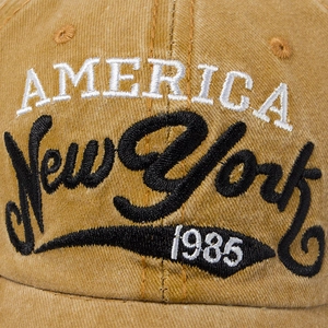 Mustard yellow washed cotton baseball cap with vintage America New York 1985 embroidery