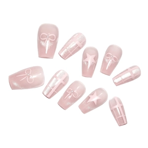 Pink cat eye press-on nails with sweet bow, star patterns, and glitter details