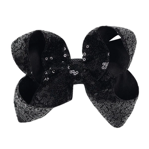 Detail view of 5-inch black sequin bow hair clip showing shimmering fabric texture