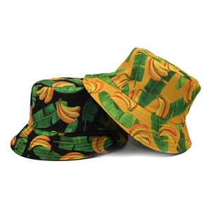 Detailed close-up of double-sided banana print bucket hats in black and yellow cotton
