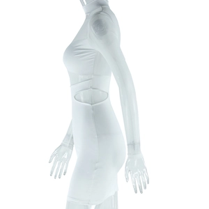 Detail of white bodycon dress featuring mesh sleeves and waist cut-out accents