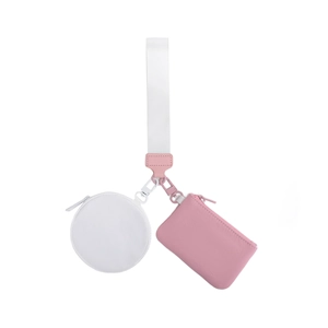 Detail of pink and white multi-pocket wristlet featuring round and rectangular coin pouches