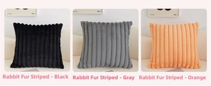 Detail of plush faux rabbit fur pillow covers in black, grey, and orange striped texture