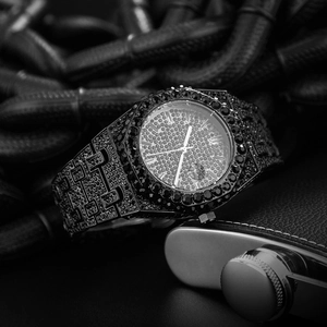 Macro shot of luxury all-black iced out men watch with octagonal bezel and diamond dial