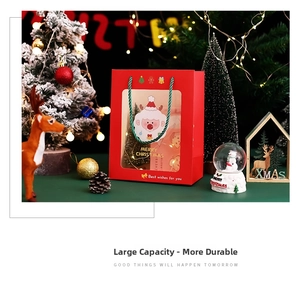 Detail of Christmas gift bag with transparent window and festive red handle design